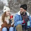 couple sitting in snow wearing Finvizo beanies holding warm mugs outdoors