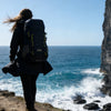 Finvizo hiker with best hiking backpack on mountain trail at golden hour