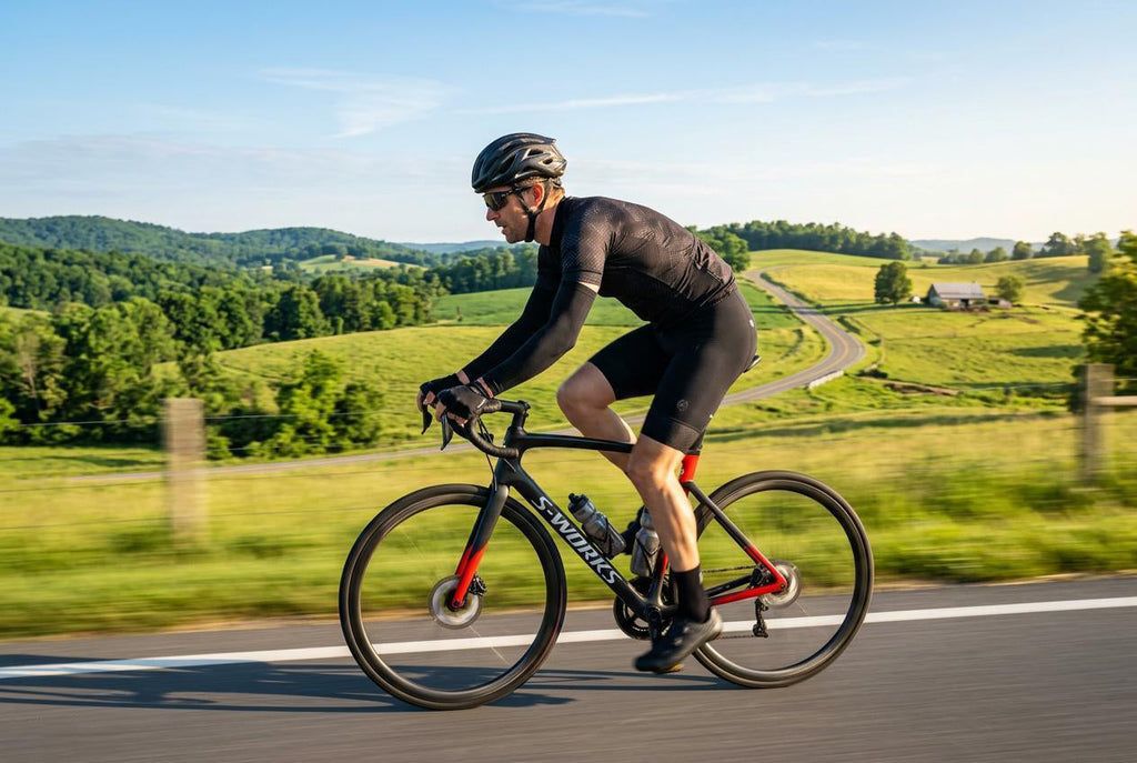 Finvizo UV arm sleeves for cyclist on sunny road ride — sun protection cycling sleeves vs cream