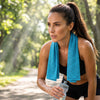 Finvizo cooling towel around a runner's neck on a sunny park path - ice towel