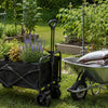 Finvizo folding wagon next to a wheelbarrow in a backyard garden
