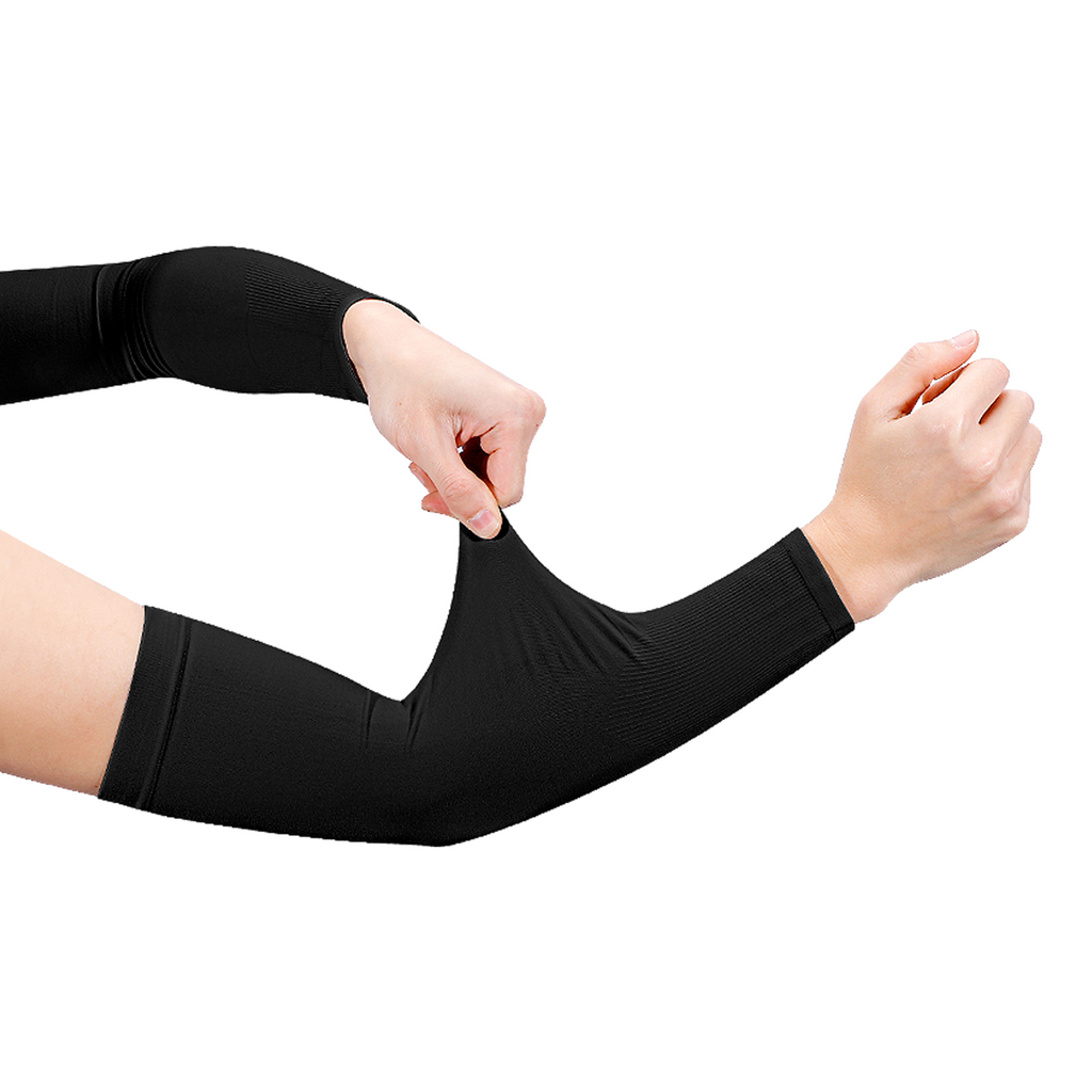 Player pulling on a black football arm sleeve for turf burn and sun protection