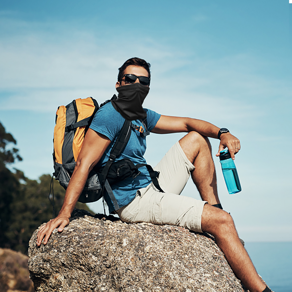 Golfer wearing a cooling neck gaiter and sunglasses for sun protection on a sunny day outdoors