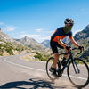 Finvizo cyclist wearing colorful summer neck gaiter on sunny mountain road