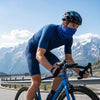 Finvizo cyclist wearing UPF neck gaiter on sunny mountain road adventure