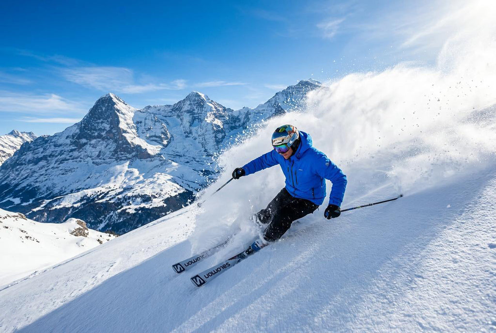 Finvizo skier wearing blue balaclava on snowy mountain peak