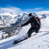 Skier wearing a balaclava seated under goggle frames for fog-free vision on a snowy slope