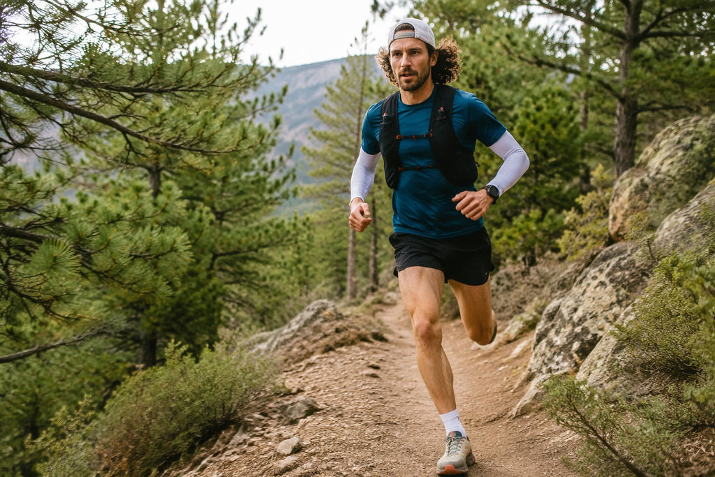 Finvizo UV Arm Sleeves and 45L Backpack for trail runners on a mountain ridge in Utah - trail running safety gear pack light