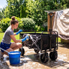 Hosing down a tent rainfly and wiping a wagon cart during a backyard gear cleaning