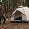 A tent pitched incorrectly on sloped uneven ground with sagging fabric