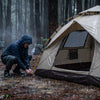 Heavy rain beading off a tent rainfly at a wet forest campsite