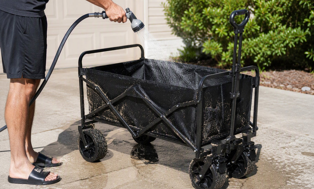 Rinsing sand off a Finvizo folding wagon in a driveway after a beach trip
