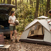 `Finvizo instant pop up tent pitched at a sunny forest campsite with a couple - 2 person pop up tent`