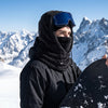 Snowboarder wearing a black Finvizo fleece balaclava on a snowy slope - snowboard gear