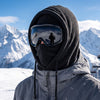 Skier wearing a black Finvizo polar fleece balaclava on a snowy slope - fleece ski mask