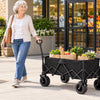 Senior woman pulling a Finvizo folding wagon cart loaded with groceries outside a store