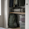 Finvizo backpack and packed tent stored neatly in a small apartment closet